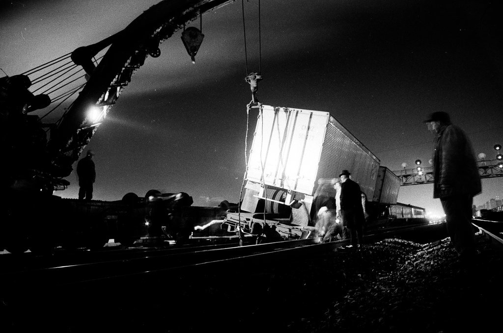 Overturned rail car carrying a semi truck - Chicago Sun-Times