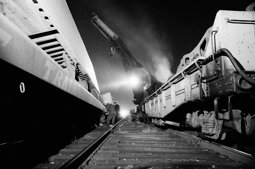 Overturned rail car carrying a semi truck - Chicago Sun-Times