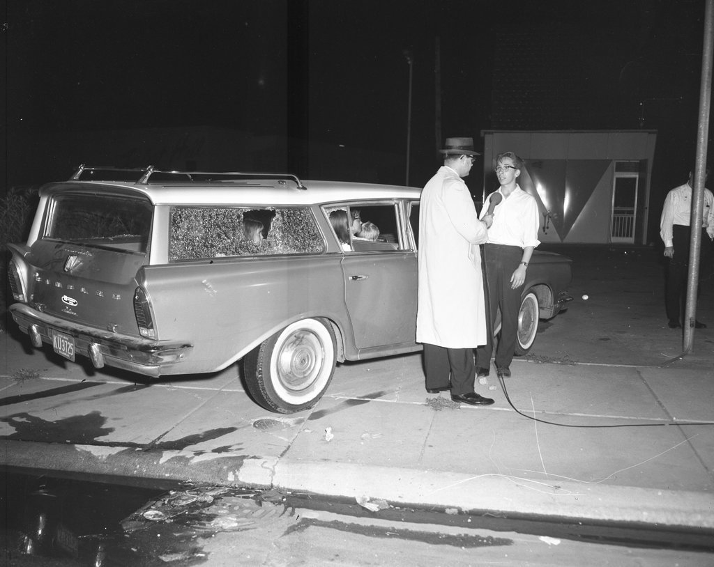 Reporter interviewing Jim Fitzpatrick Jr. after his family's car was hit with rocks during a riot in Dixmoor, Illinois - Chicago Sun-Times