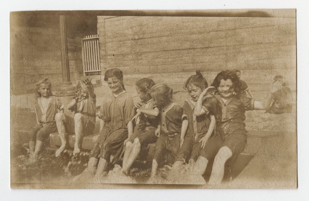 Children splashing feet in the water at the Mary McDowell Settlement House