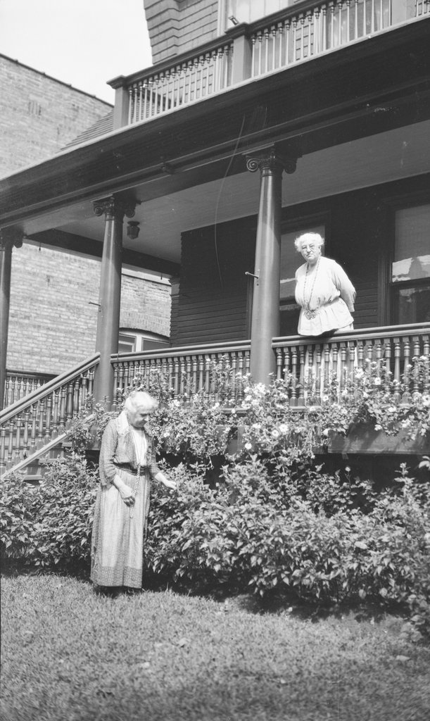 Two women outside a house, possibly Mary McDowell