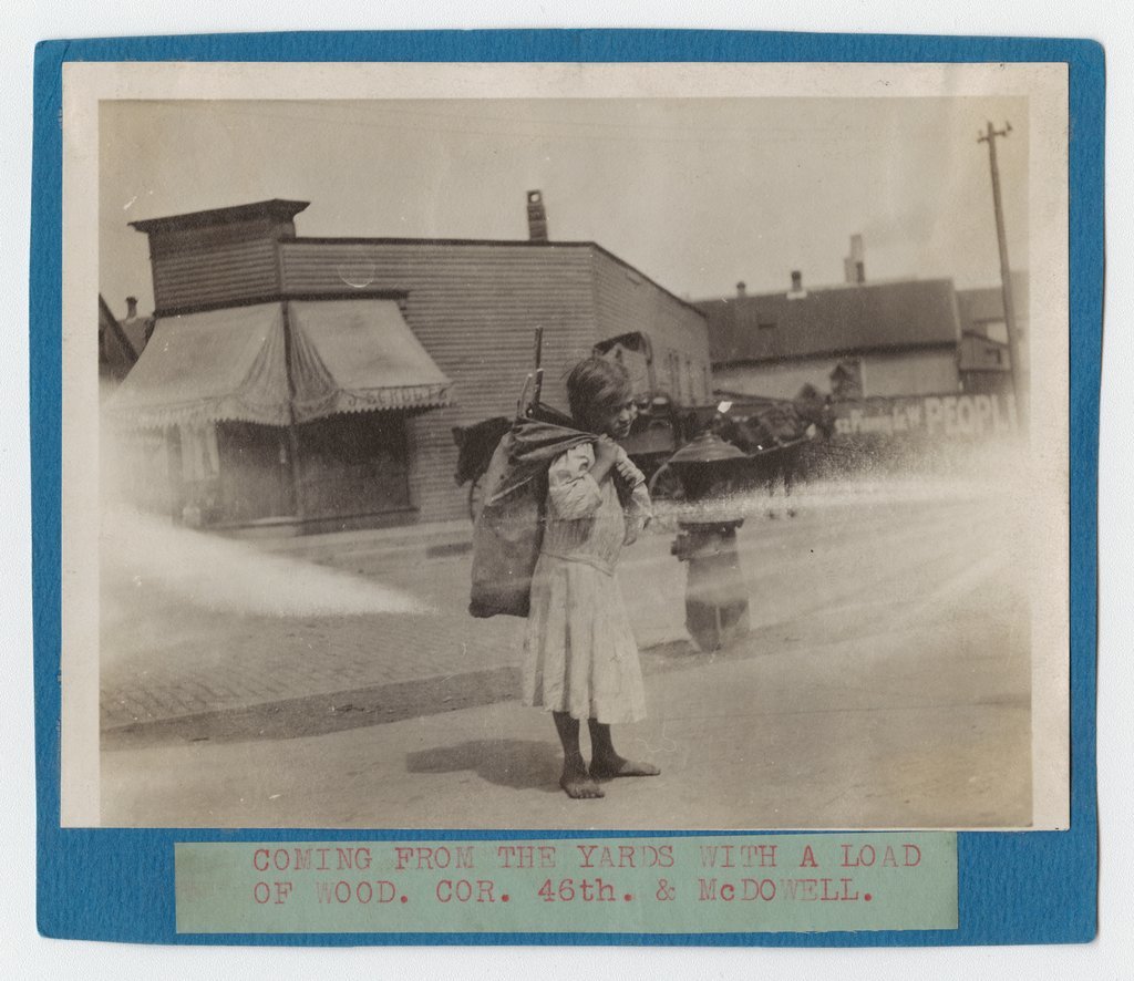 Child carrying wood near Back of the Yards neighborhood