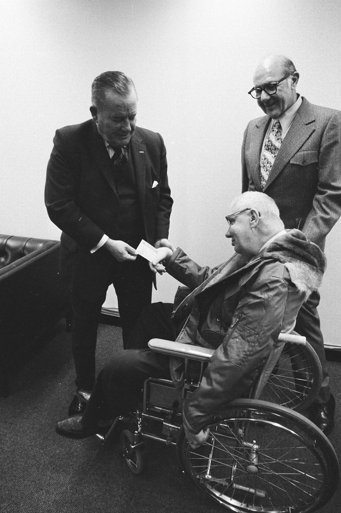 Earl Klein who uses a wheelchair receives voter ID card - Gene Pesek for Chicago Sun-Times
