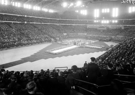 Large flower cross in auditorium filled with people - Chicago Daily News, Inc.