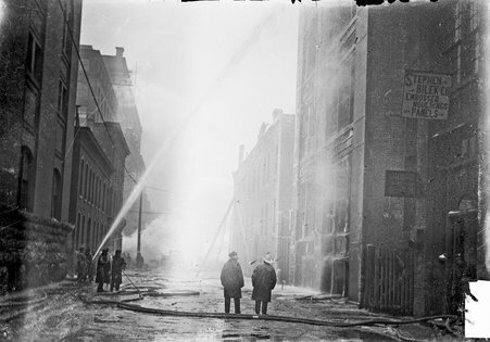 Firefighters spraying water during the Iroquois Theater fire - Chicago Daily News, Inc.