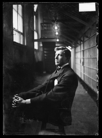 Car barn bandit Gustave Marx sitting in a prison corridor - Chicago Daily News, Inc.