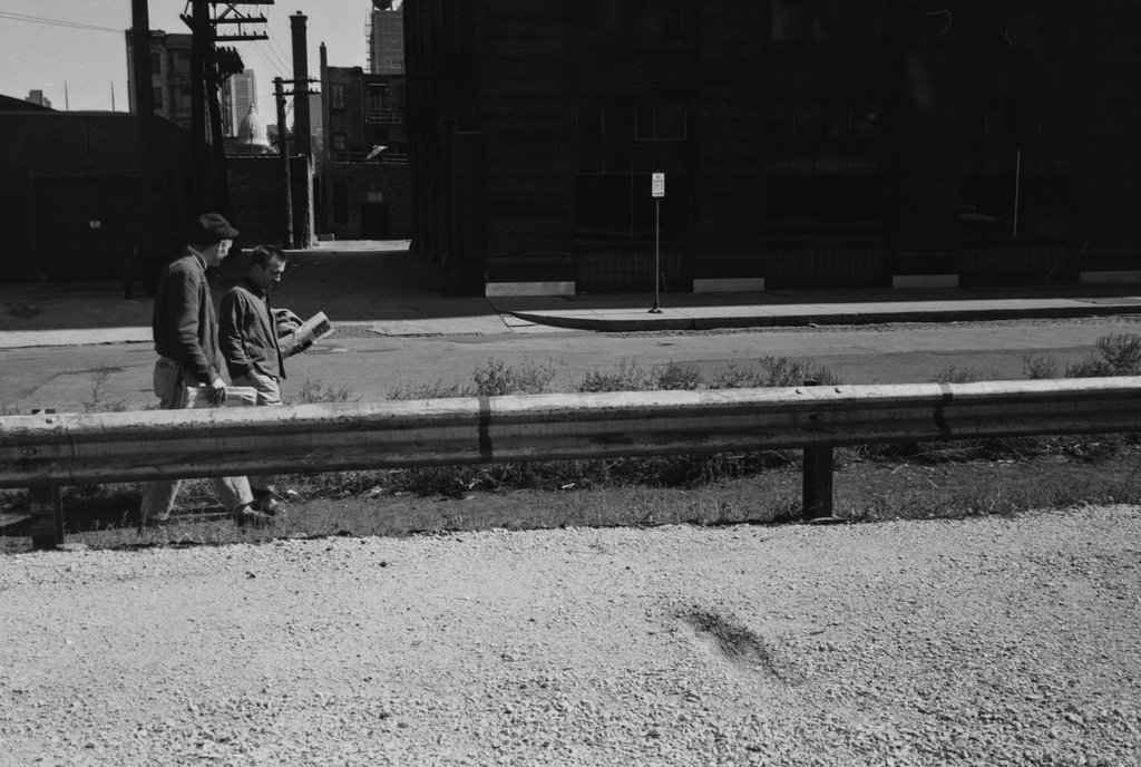 Two people walking next to a guardrail - Haun, Declan, 1937-1994