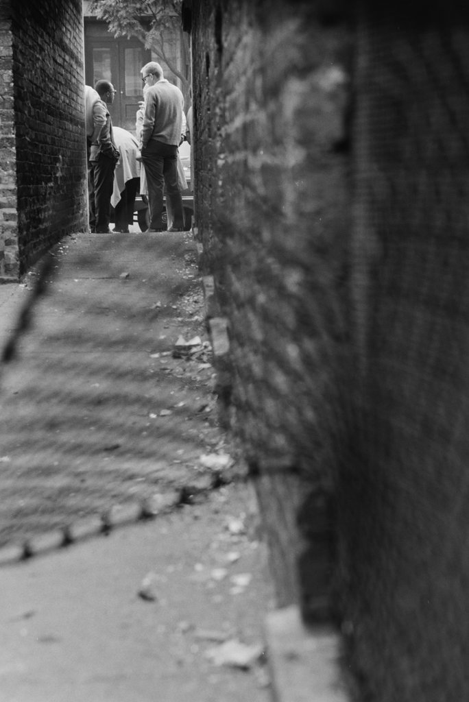 People standing next to an alley - Haun, Declan, 1937-1994
