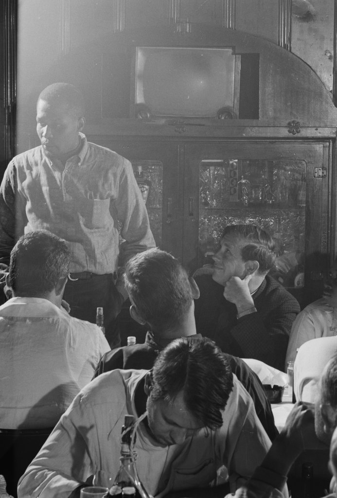 Group of people in a meeting at a bar or restaurant - Haun, Declan, 1937-1994