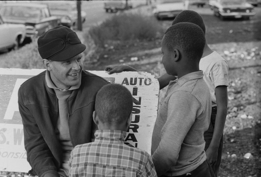 Adult talking to three children - Haun, Declan, 1937-1994
