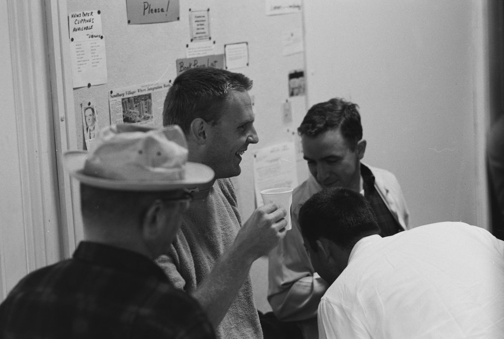 Group of people enjoying refreshments and conversing - Haun, Declan, 1937-1994