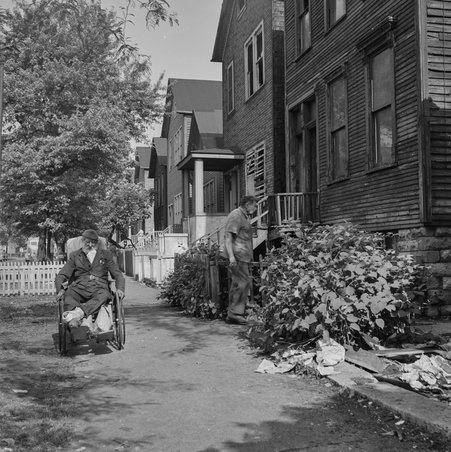 Man sits on wheelchair on West 42nd Street in Fuller Park - Mead, Mildred