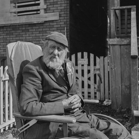 Man sits in wheelchair on West 42nd Street in Fuller Park - Mead, Mildred
