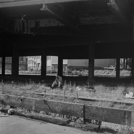 Man sits under overpass in River North - Mead, Mildred