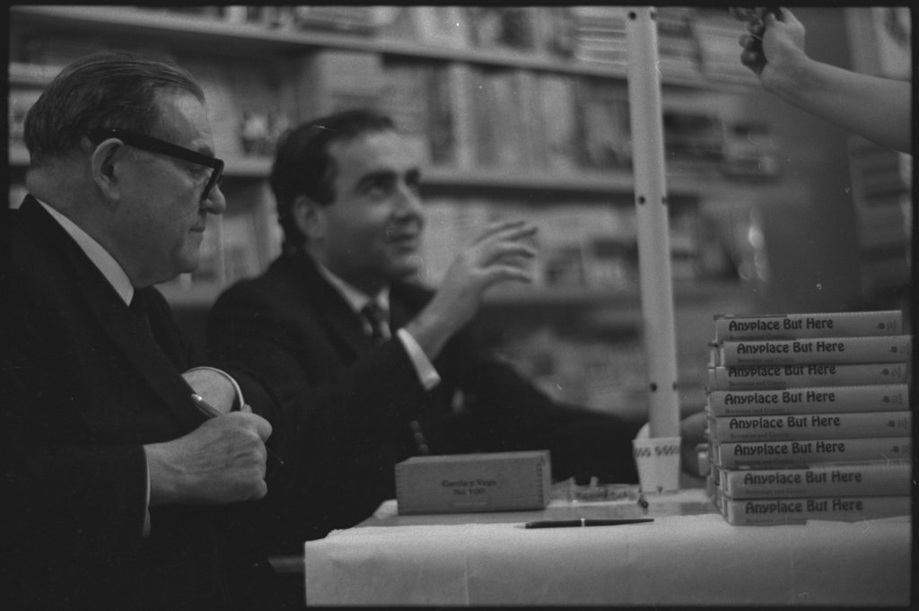 Writer Jack Conroy signing copies of 'Anyplace But Here' - Flerlage, Raeburn, 1915-2002