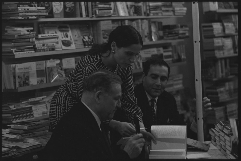 Writer Jack Conroy signing copies of 'Anyplace But Here' - Flerlage, Raeburn, 1915-2002
