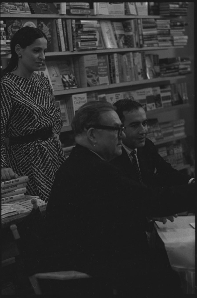 Writer Jack Conroy signing copies of 'Anyplace But Here' - Flerlage, Raeburn, 1915-2002
