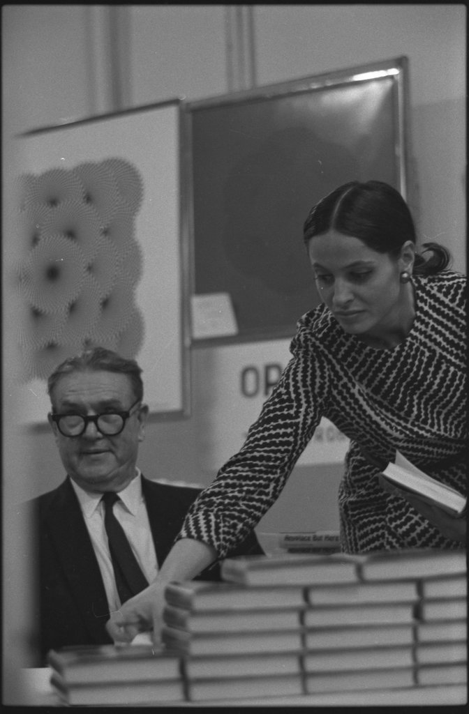Writer Jack Conroy signing copies of 'Anyplace But Here' - Flerlage, Raeburn, 1915-2002