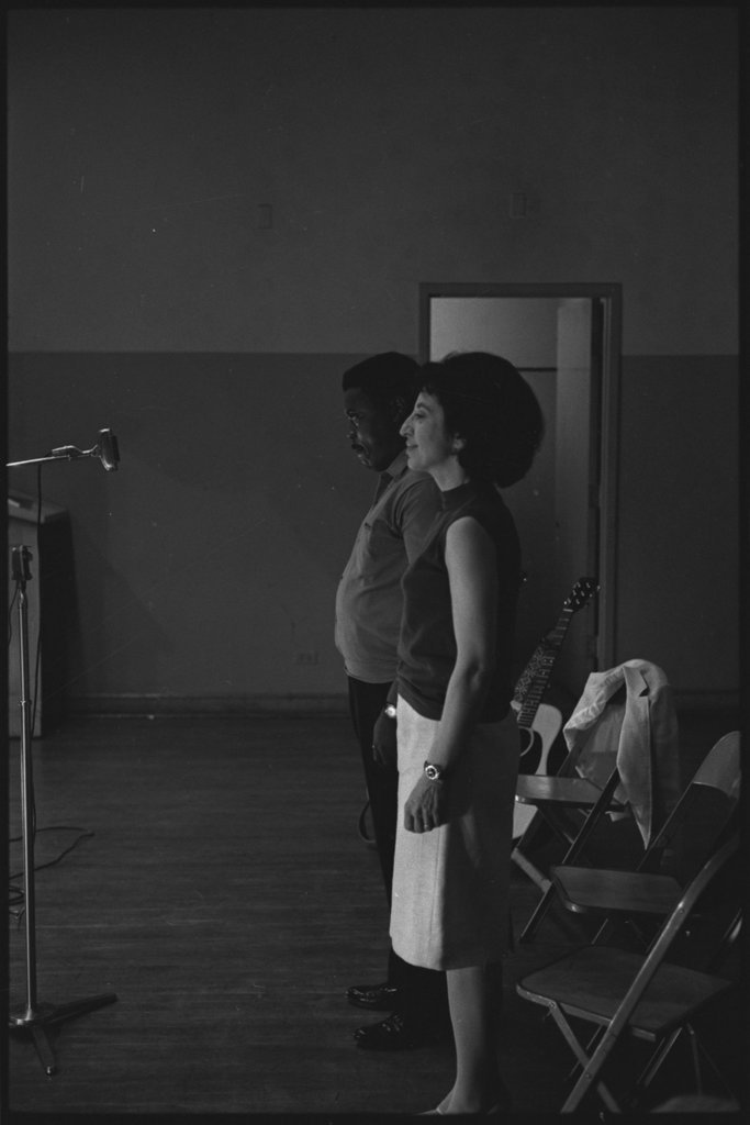 Folk singers performing in a school auditorium - Flerlage, Raeburn, 1915-2002