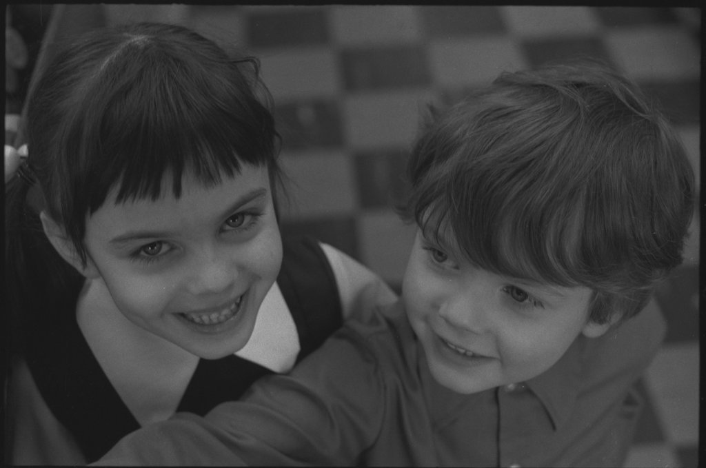 Unidentified man and children in record store - Flerlage, Raeburn, 1915-2002