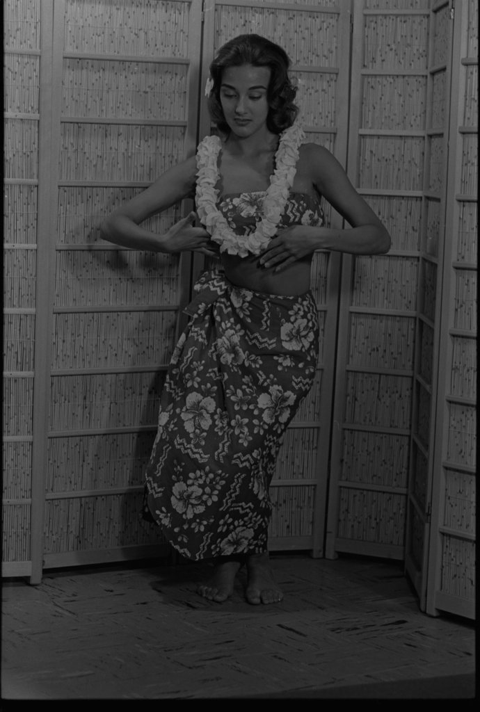 Model posing in a grass hula skirt - Flerlage, Raeburn, 1915-2002