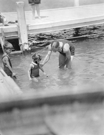 Man with two children in pool - Trowbridge, Raymond W., 1886-1936