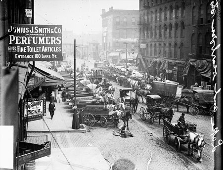 Horse-drawn wagons and carriages on North Dearborn Street - Chicago Daily News, Inc.