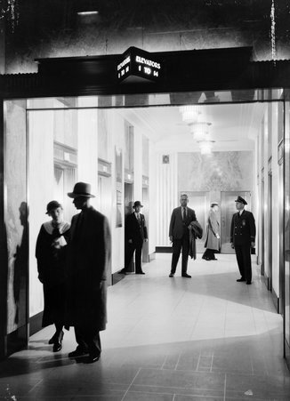 Interior view of elevator lobby with people, Field Building - Hedrich-Blessing