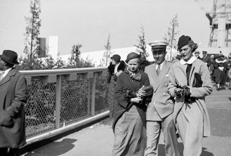 Three fair-goers walking across bridge at Century of Progress - Cook, O. L.