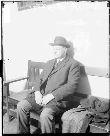 Patrick Sexton, sitting on a wooden bench - Chicago Daily News, Inc.