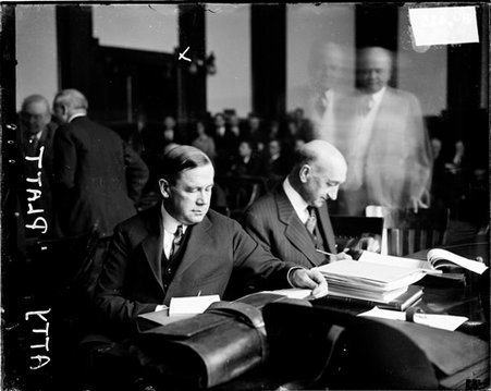 Attorney. Henry Russell Platt sitting at a desk covered with papers - Chicago Daily News, Inc.