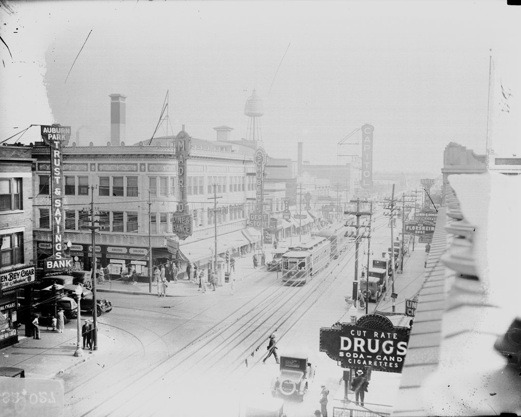 Pedestrians and automobiles and streetcars driving on Halsted Street at 79th Street in the Auburn Gresham community area - Chicago Daily News, Inc.