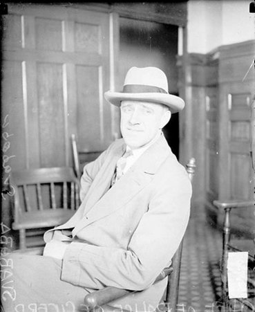 Police Chief Svaboda of Cicero, Illinois, sitting in a room - Chicago Daily News, Inc.