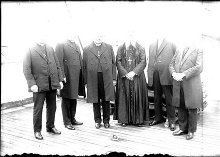 International Eucharistic Congress with six clergymen standing on the deck of a boat - Chicago Daily News, Inc.