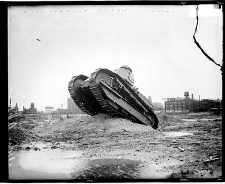 Tank driving over a large bump on a dirt field as part of a military tournament in Chicago - Chicago Daily News, Inc.