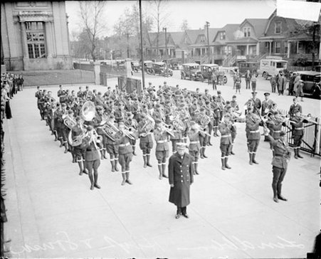 Band master and composer John Phillip Sousa standing with Lindblom High School marching band in a plaza in front of the school - Chicago Daily News, Inc.