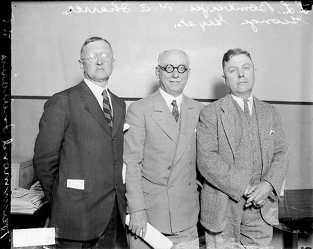 L. L. Bomberger, George Gever, and H. E. Sharrer of Hammond, Indiana looking toward the camera and standing in a room - Chicago Daily News, Inc.