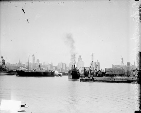 Two ships sailing near the entrance of the Chicago River with skyline visible in the background - Chicago Daily News, Inc.