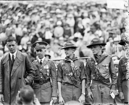 Aviator Charles A. Lindbergh standing next to a group of Boy Scouts in front of a large crowd at Soldier Field - Chicago Daily News, Inc.