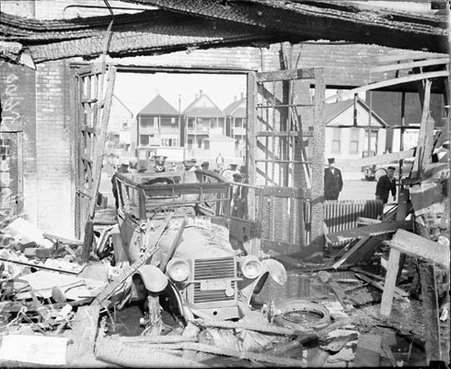 Debris and wreckage surrounding an automobile in a destroyed building - Chicago Daily News, Inc.