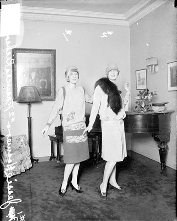 Jessie Hosmer and Frances Richardson posing in front of a piano in a room - Chicago Daily News, Inc.