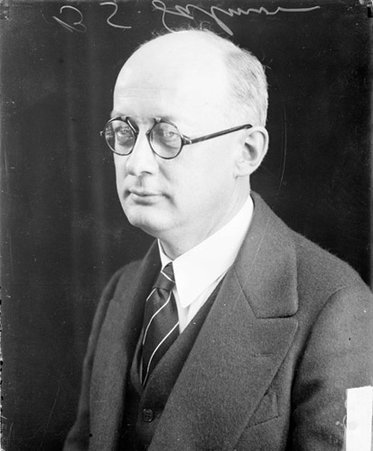 B. S. Salmon facing to the left of the camera, sitting in front of a backdrop in a room - Chicago Daily News, Inc.