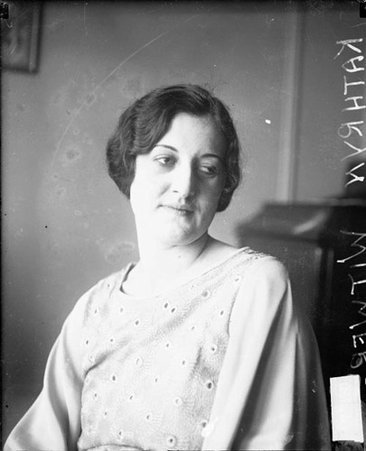 Kathryn Witwer looking to her left, sitting in a room - Chicago Daily News, Inc.