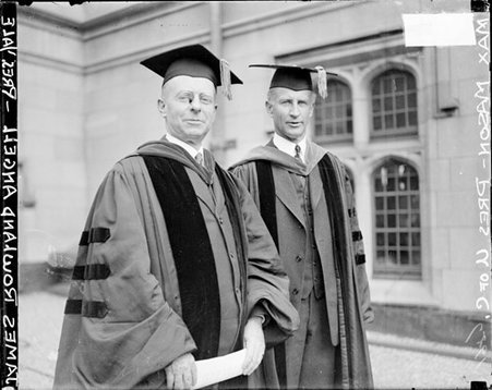 James Rowland Angell and Max Mason facing to the right, wearing scholarly robes standing in front of a building - Chicago Daily News, Inc.