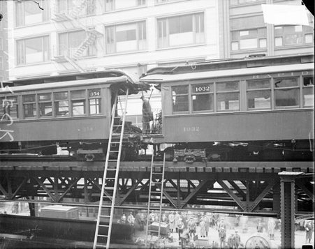 Train conductor standing on the rear platform of an elevated train car after an accident on the track - Chicago Daily News, Inc.