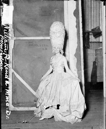 Mrs. William P. Rend wearing a costume and wig, standing backstage in an auditorium - Chicago Daily News, Inc.