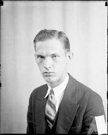 Bob Stanton looking toward the camera, sitting against a light-colored backdrop in a room - Chicago Daily News, Inc.