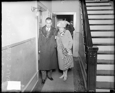 Mr. and Mrs. Forsythe Sherfesse standing in a hallway in a building - Chicago Daily News, Inc.