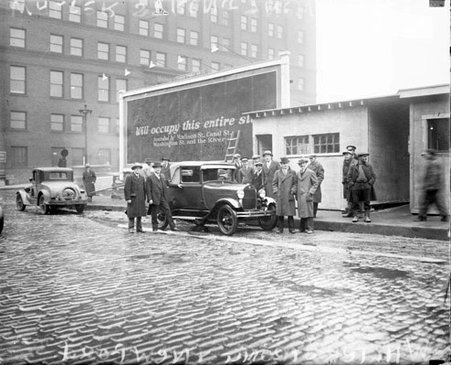 Walter Strong standing with an unidentified man standing on the passenger side of a new Ford automobile, light exposure - Chicago Daily News, Inc.
