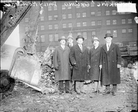 Five men standing amid rubble and debris at a construction site, dark exposure - Chicago Daily News, Inc.